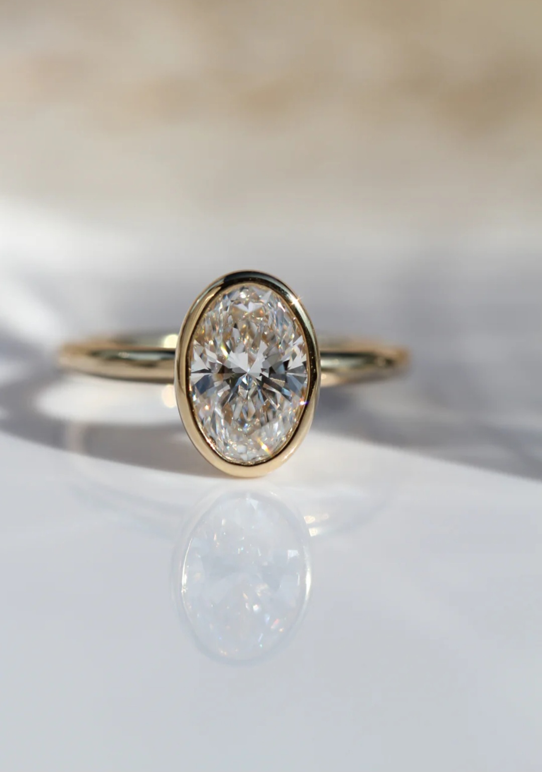 Oval bezel moissanite engagement ring shown from the front